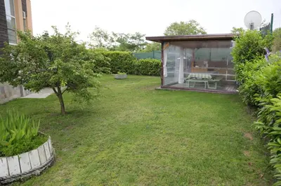 a small garden with a shed and a tree at Lux Sozopoli Hills Apartments A19 и Studio А13 in Sozopol