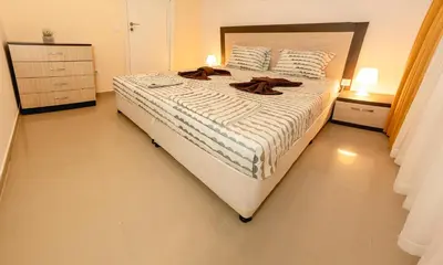 a bedroom with a large bed with shoes on it at Sunset Vibes in Arapya - Breathtaking Views and Pool - by Flаt Manаger in Arapya