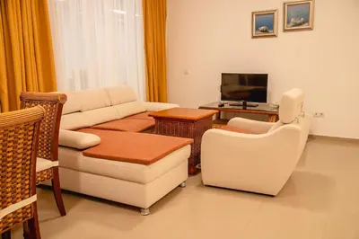 a living room with a couch and chairs and a television at Sunset Vibes in Arapya - Breathtaking Views and Pool - by Flаt Manаger in Arapya
