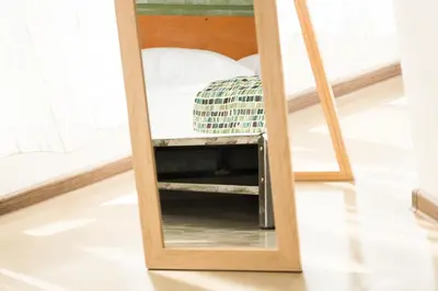 a mirror sitting on a floor next to a bed at VIDA in Lozenets
