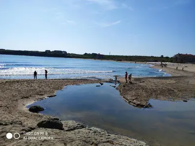 a group of people standing on a beach at INESA in Tsarevo
