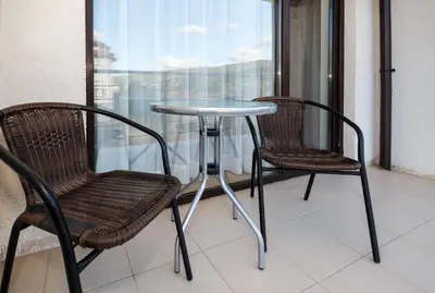 two chairs and a table on a balcony at Charming 1 Bedroom Apartment for up to 4 Guests in Sunny Beach