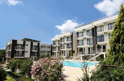 an apartment complex with a swimming pool and flowers at Charming 1 Bedroom Apartment for up to 4 Guests in Sunny Beach