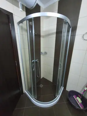 a shower with a glass door in a bathroom at Таня 11 in Pomorie