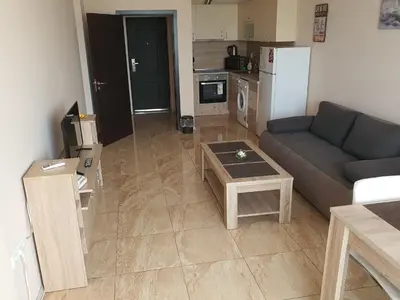 a living room with a couch and a table at Таня 11 in Pomorie