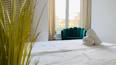 a bedroom with a bed with two towels on it at APARTELLO Modern Apartments in DownPARK in Sunny Beach