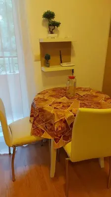 a table in a room with a table and chairs at Апартаменты Aphrodite Roce in Sunny Beach