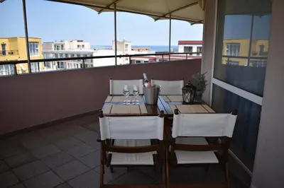 a table and chairs on a balcony with a view at хотел Свети Николай Приморско in Primorsko