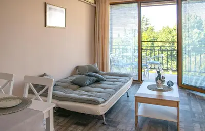 a living room with a couch and a table at Briz MK Apartment in Ravda