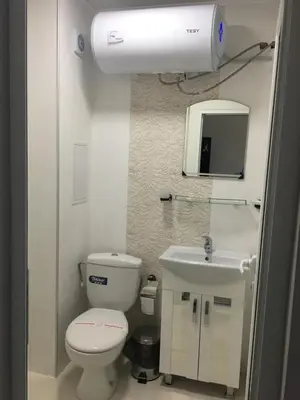 a bathroom with a toilet and a sink and a mirror at Хотел Paradise in Tsarevo