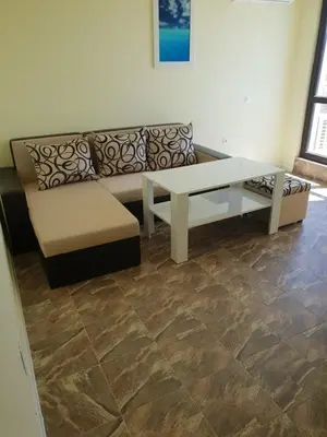 a living room with a couch and a coffee table at Хотел Paradise in Tsarevo