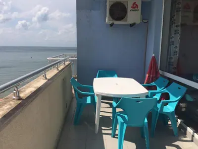 a table and chairs on a balcony with the ocean at Апартамент с две спални в комплекс Лъки 2 Свети Влас in Sveti Vlas