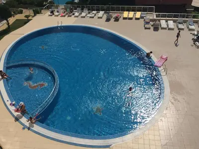an overhead view of a swimming pool with people in it at Апартамент с две спални в комплекс Лъки 2 Свети Влас in Sveti Vlas