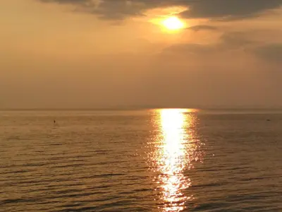 an image of the sun setting over the ocean at PARUS-2-STUDIO in Pomorie