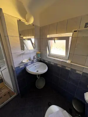 a small bathroom with a sink and a mirror at Kъща за гости Христина in Lozenets