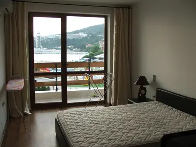 a bedroom with a bed and a large window at Apartamens for rent at the beach bulgaria in Sveti Vlas