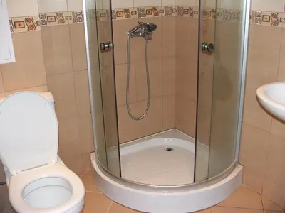 a bathroom with a shower with a toilet and a sink at Apartamens for rent at the beach bulgaria in Sveti Vlas