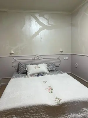 a bedroom with a large bed with a white blanket at Santa Marina Apartment 503 in Sozopol