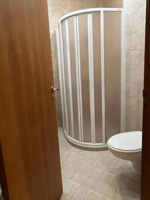 a bathroom with a toilet and a metal gate at Santa Marina Apartment 503 in Sozopol