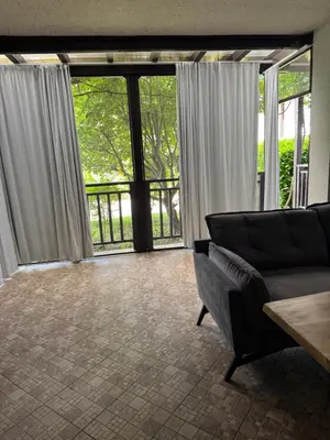 a living room with a couch and large windows at Santa Marina Apartment 503 in Sozopol