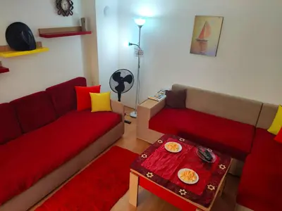 a living room with two red couches and a table at Studio Yana *Top location*Sea Garden* in Varna City