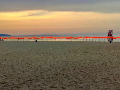 a row of orange umbrellas on the beach at Studio Yana *Top location*Sea Garden* in Varna City