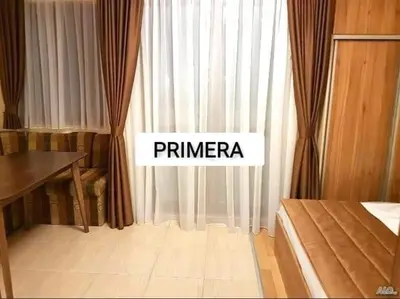 a bedroom with a bed and a window with curtains at APARTAMENT PRIMERA in Varna City