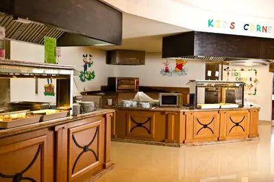 a restaurant kitchen with a counter with food at DIT Majestic Beach Resort in Sunny Beach
