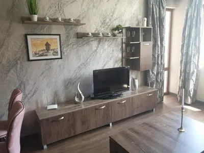 a living room with a television on a wooden cabinet at Mit Prot luks Apartment Panorama Bay 2 ap109 in Sveti Vlas
