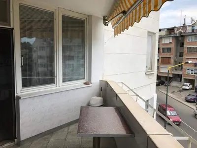 a bench sitting on the balcony of a building at Апартамент Вангелов in Nesebar