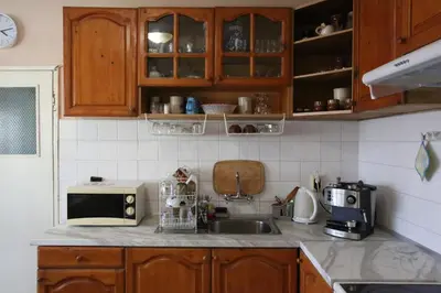 a kitchen with a sink and a microwave at Апартамент Вангелов in Nesebar