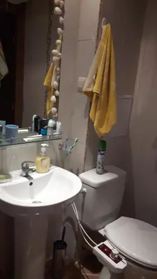 a bathroom with a sink and a toilet and a mirror at Hacienda Beach Apartment mit Meerblick in Sozopol