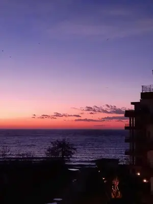 a sunset view of the ocean from a building at Stensi Atlantis studia in Ravda