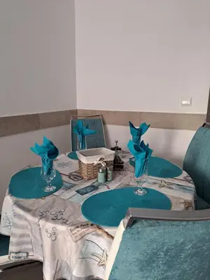 a table with blue plates on top of it at Stensi Atlantis studia in Ravda