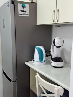 a kitchen counter with a blender and a refrigerator at Stensi Atlantis studia in Ravda