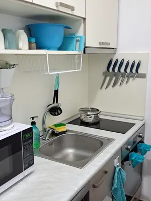 a kitchen with a sink and a microwave at Stensi Atlantis studia in Ravda