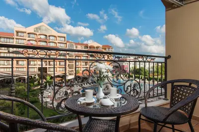 a balcony with a table and chairs and a view of a building at Hotel & SPA Diamant Residence - All Inclusive in Sunny Beach