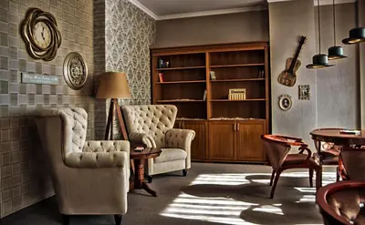 a living room with two chairs and a book shelf at Hotel & SPA Diamant Residence - All Inclusive in Sunny Beach