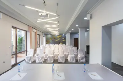 a conference room with white chairs and a long table at Hotel & SPA Diamant Residence - All Inclusive in Sunny Beach