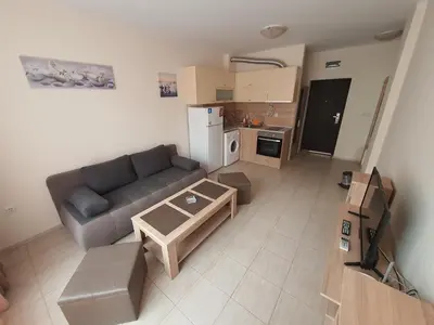 a living room with a couch and a table at Таня 10 in Pomorie