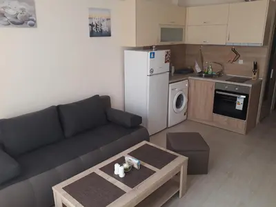 a living room with a couch and a kitchen at Таня 10 in Pomorie