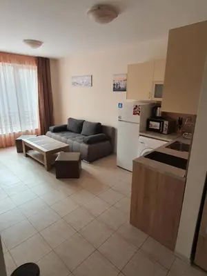 a kitchen and a living room with a couch at Таня 10 in Pomorie