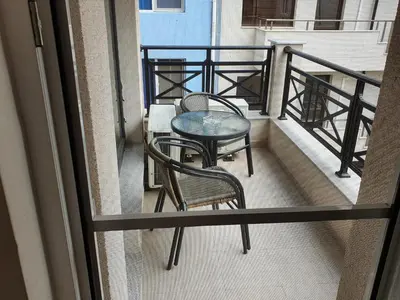 a balcony with two chairs and a table on it at Таня 10 in Pomorie