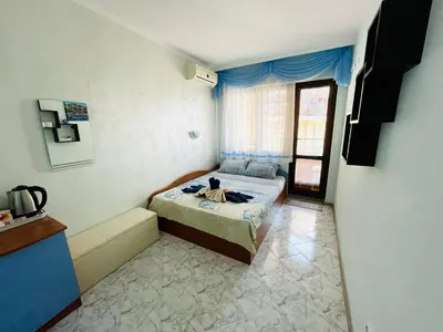 a small bedroom with a bed and a window at Kastela Guest House in Chernomorets