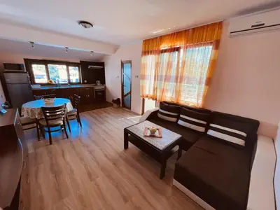 a living room with a couch and a table at Kastela Guest House in Chernomorets