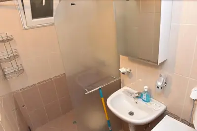 a small bathroom with a sink and a mirror at City apartments in Varna City