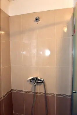 a shower with a shower head in a bathroom at City apartments in Varna City