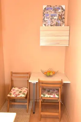 a table with two chairs and a bowl of fruit at City apartments in Varna City