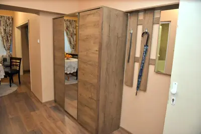 a large wooden door in a room with a table at City apartments in Varna City