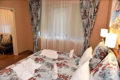 a bedroom with a bed and a window at City apartments in Varna City
